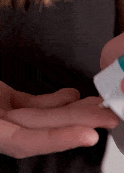 GIF of woman applying All Good Tinted Sunscreen Lotion to her hand.